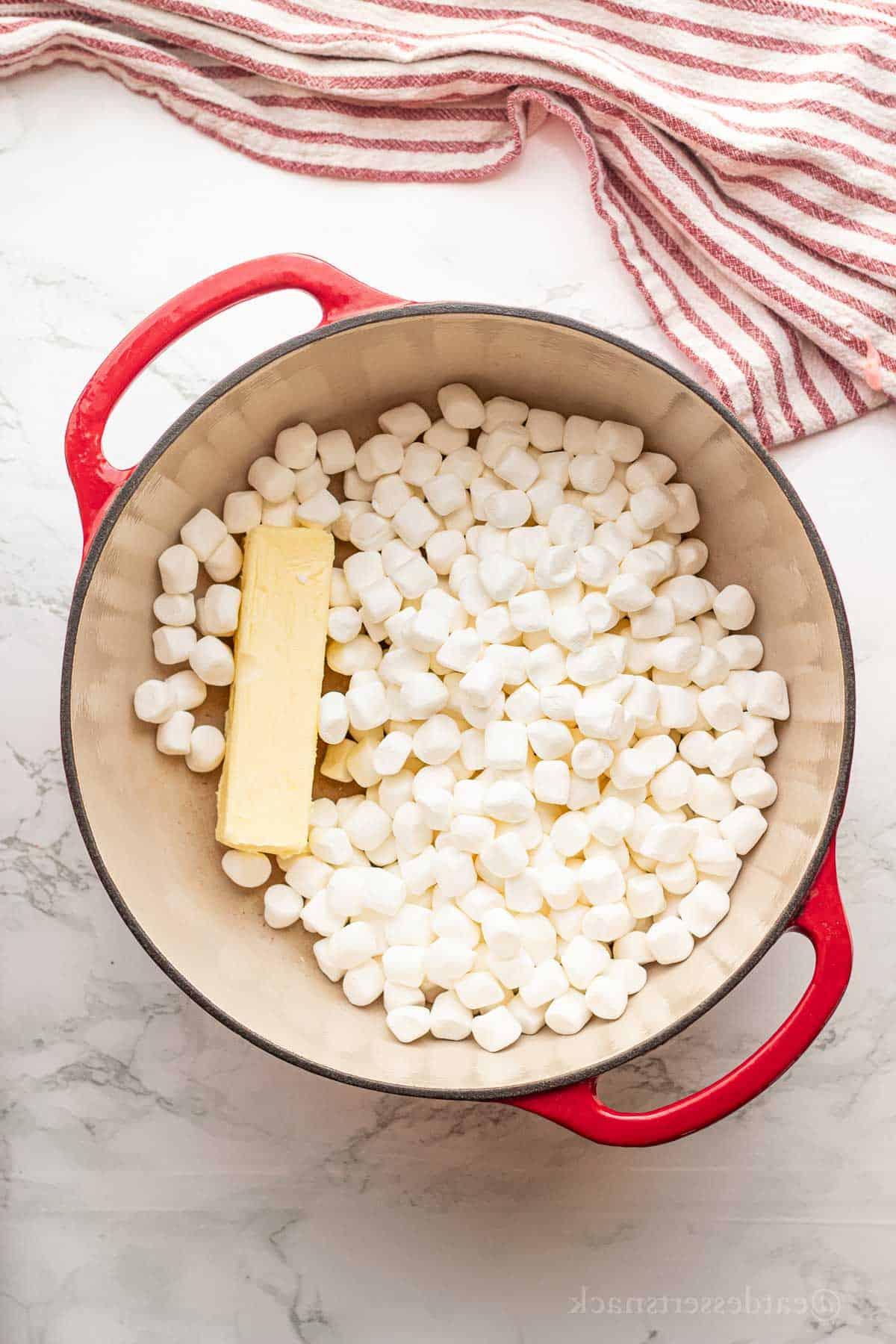 Marshmallows and butter in red pot.