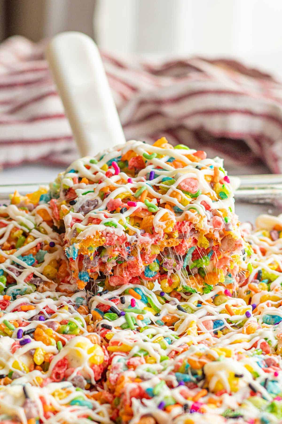 Spatula with slice of fruity pebble rice crispy treat.
