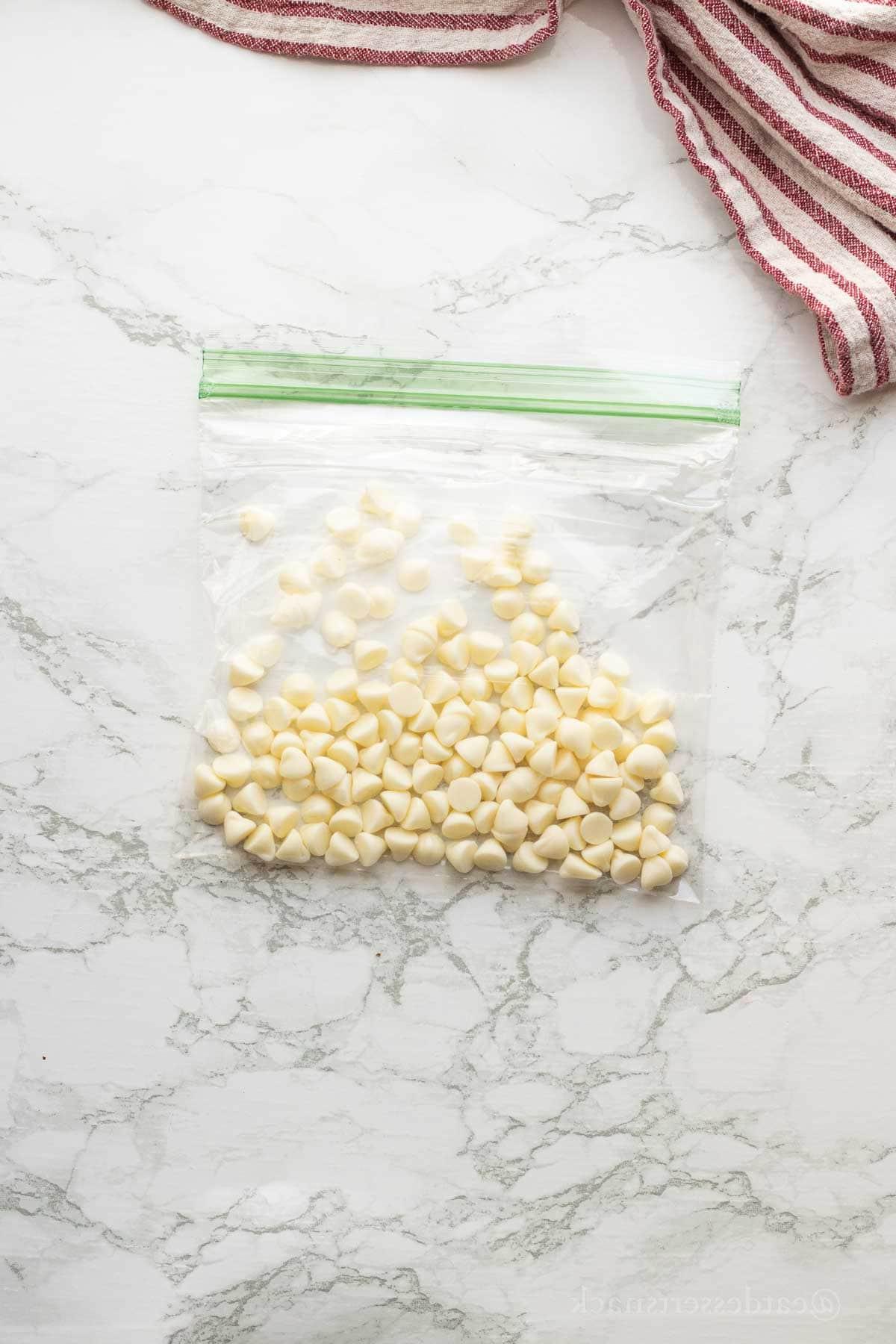 White chocolate chips in zip close bag.